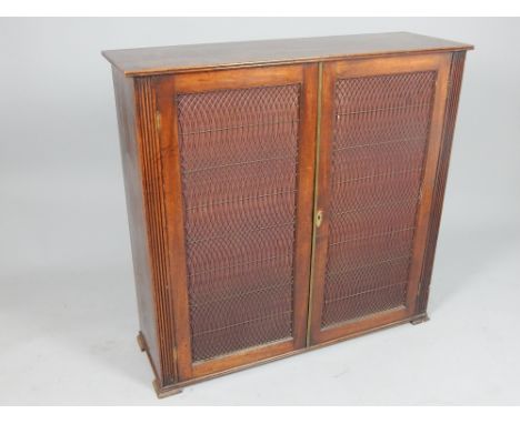 Recency mahogany cupboard in the form of a chiffonier, the rectangular top above a pair of brass grille and silk lined doors 