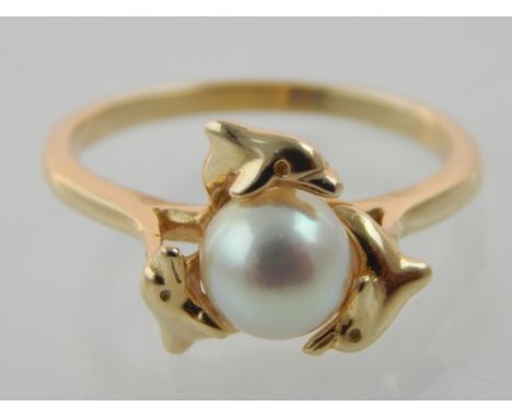 14ct yellow gold dress ring, the setting depicting three dolphin encircling a natural pearl, 3.3g