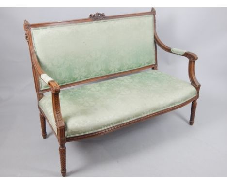 Louis XVI walnut framed two seat sofa, with pad back above open arms and overstuffed seat, on turned spiral fluted legs, 132c