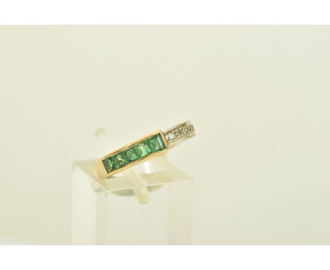 A YELLOW METAL EMERALD AND DIAMOND DRESS RING, of geometric design channel set with five graduated calibre cut emeralds and f