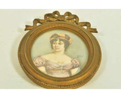 A LATE 19TH CENTURY MINIATURE PORTRAIT, depicting an elegant lady with head dress, mounted within an ornate frame with bow su