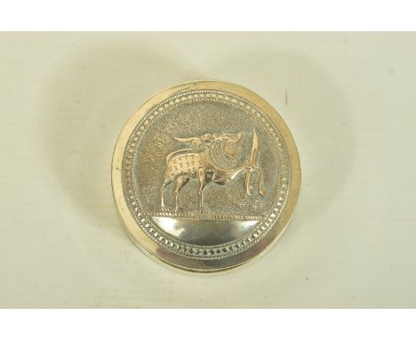 AN INDIAN WHITE METAL BOX, the circular box with scroll and floral embossed detail and fitted lid, approximate diameter 64mms