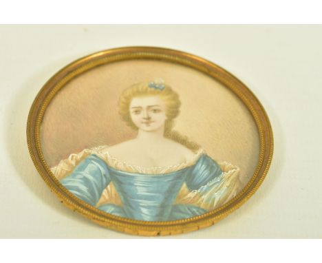 A LATE VICTORIAN MINIATURE PORTRAIT, depicting an elegant lady painted on ivory, within a base metal surmount, overall diamet