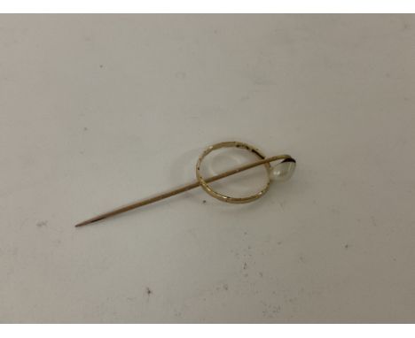 A 9ct gold pearl set stick pin together with a 9ct gold band.