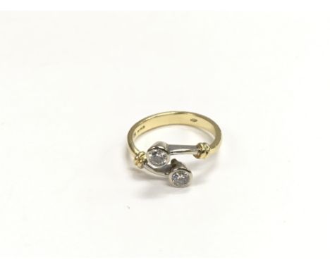 An 18ct gold ring set with two solitaire diamonds, approx 3.3g and approx size K-L.