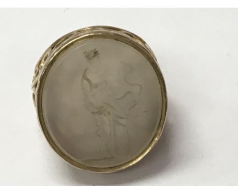 A gold ring inset with intaglio in the form of Medusa size R .