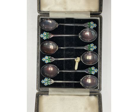 A cased set of 6 hallmarked silver and enamel spoons with flower finials, together with 3 additional hallmarked silver and en