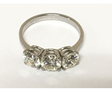 A Quality brilliant cut diamond ring. set with three diamonds. Total 2.45 total carat weight. Colour K/L clarity SI total wei