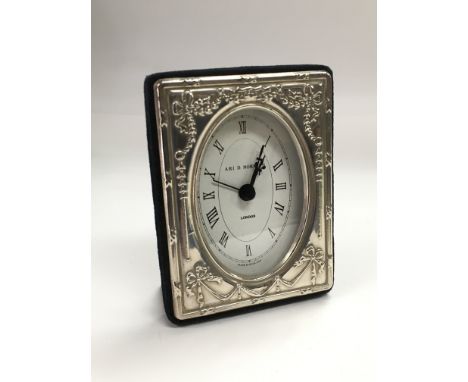A boxed D Norman silver cased clock.