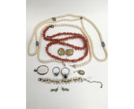 A collection of jewellery including two pearl necklaces, coral necklace, peridot earrings etc.