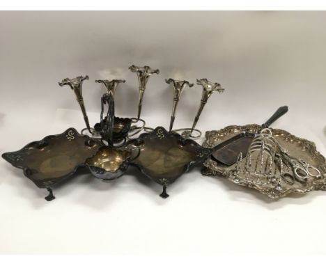 A collection of silver plated items comprising a twin strawberry dish with cream jug and sugar bowl, five branch epergne, two