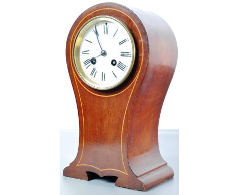 An Edwardian early 20th century inlaid mahogany 8 day balloon / mantel clock having a white enamel clock face with Roman nume