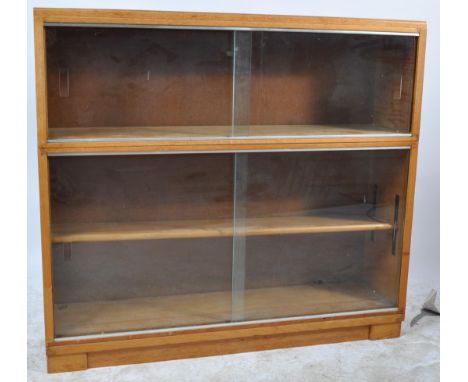 A retro vintage 1970s 20th century Minty lawyers stacking oak framed bookcase having three compartments raised on an upright 