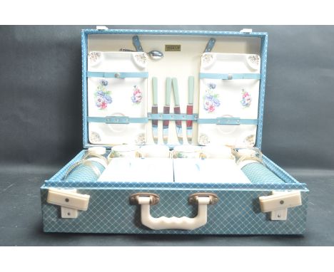 A vintage retro 20th century circa 1960’s picnic set by Brexton set within blue leatherette case compete with ceramic sandwic