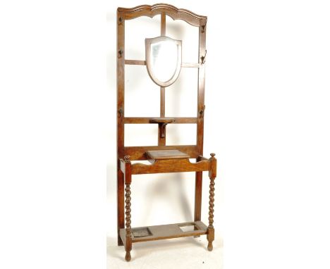 An early 20th Century circa 1920s oak framed hall stand having a central&nbsp; bevelled mirror in a shape of a shield flanked