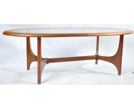 A retro vintage 20th century circa 1970s teak wood Astro style coffee table of oval form having a drop in glass centre raised
