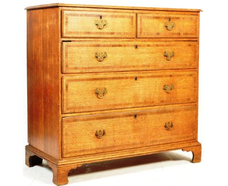 A 19th century George IV oak and mahogany cross banded chest of drawers. The chest of drawers having a two over three drawers