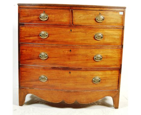 A late 18th Century George III mahogany bow front chest of drawers. The bow fronted bank of two over three drawers having bra