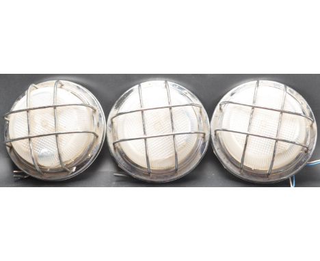 A set of three vintage retro late 20th century circa 1980’s factory industrial wall light / wired cage light of a circular fo