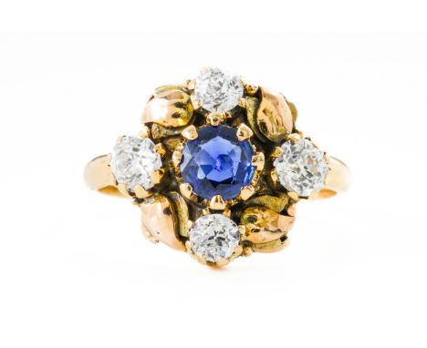 A SAPPHIRE AND DIAMOND RINGWith a central round cut sapphire surrounded by four old cut diamonds and leaf motifs, in yellow g