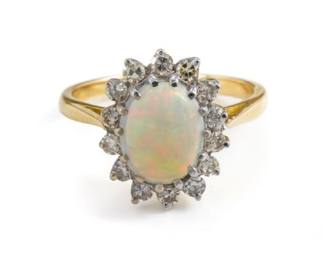 AN OPAL AND DIAMOND CLUSTER RINGWith central oval cabochon opal with a surround of single cut diamonds, all claw set in yello