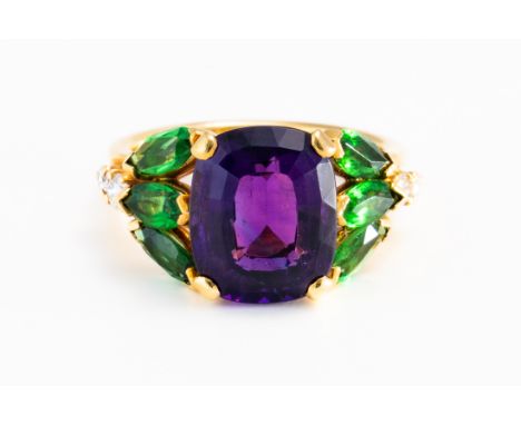 A GOLD, AMETHYST, DIAMOND AND GREEN GARNET SET RINGClaw set with the cushion shaped amethyst at the centre, between two rows 