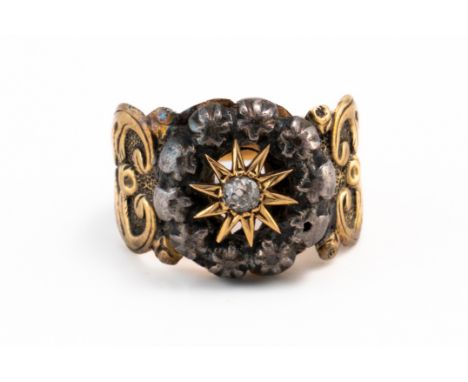 AN ANTIQUE DIAMOND STAR MOTIF RINGWith central old cut diamond weighing an estimated 0.07 carats in star motif with a surroun