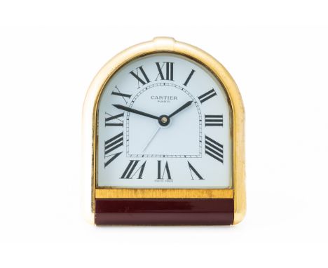 A CARTIER PARIS GILT METAL TRAVELLING ALARM CLOCKShaped as a stirrup with a battery operated movement, Must de Cartier bookle