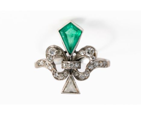 AN ART DECO EMERALD AND DIAMOND RINGFeaturing a fancy cut emerald and trilliant cut diamond in a fleur de lis design set with