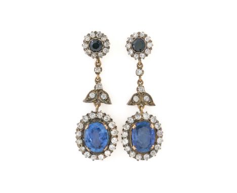 A PAIR OF SAPPHIRE AND DIAMOND CLUSTER EARRINGSEach set with a central oval cut sapphire measuring 10.90 mm x 8.23mm, with a 