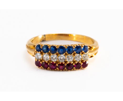 A DIAMOND, RUBY AND SAPPHIRE RINGIn a three row design, mounted with a row of seven old cut diamonds at the centre and furthe