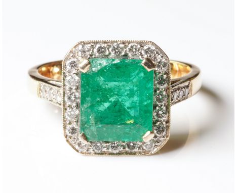 AN 18CT GOLD, EMERALD AND DIAMOND RINGClaw set with a natural emerald, with an estimated weight 4.50 carats, surrounded by tw