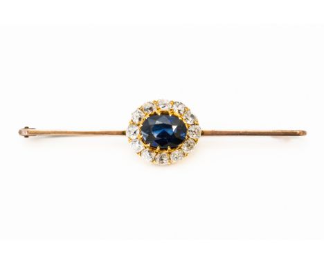 A SAPPHIRE AND DIAMOND BAR BROOCHWith central oval cut sapphire measuring 9.83mm x 7.13mm, with a surround of twelve old cut 