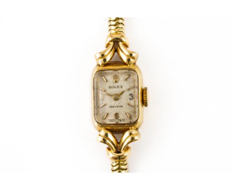 A ROLEX 18CT GOLD LADY'S BRACELET WRISTWATCHWith a signed jewelled rectangular movement, the silvered dial with gilt Arabic a