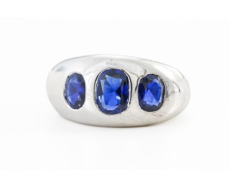 A SAPPHIRE THREE STONE RINGBezel set with three oval cut sapphires the centre measuring approximately 6.6mm x 4.7mm, and the 