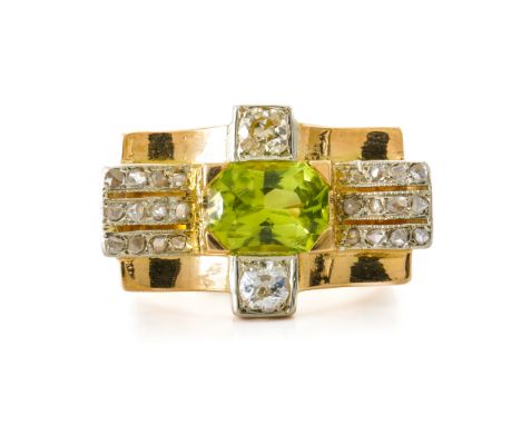 A PERIDOT AND DIAMOND RINGWith central peridot and two old cut diamonds, with rows of rose cut diamonds to the edges, mounted