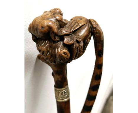 An early 20th century, novelty walking stick, with a carved bamboo handle decorated animals, inset with ivory carving of a ra