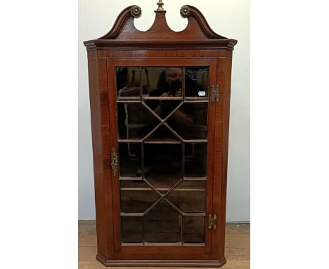 A mahogany corner cabinet, with a single glazed door, 72 cm wide