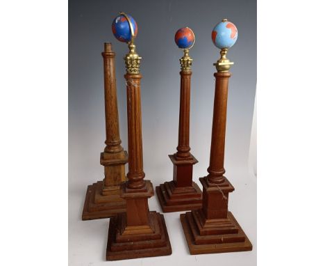 A set of four Masonic type globes raised on pillars, 50 cm high, one lacking a globe (4)