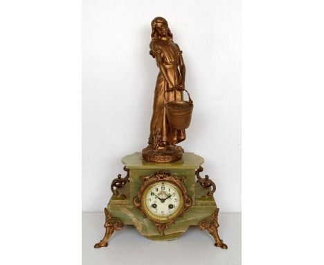 A French mantel clock, the enamel dial decorated flowers, fitted an eight day movement, in an onyx case with a gilt spelter f