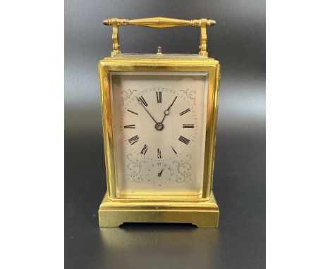 A French carriage clock, with repeast, the silvered dial with alarm dial, in a brass four pillar case, 15 cm high