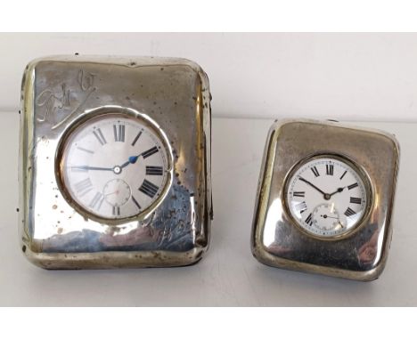 A silver mounted travelling watch case, inscribed, 10 cm wide, with a large pocket watch, and another similar (2)