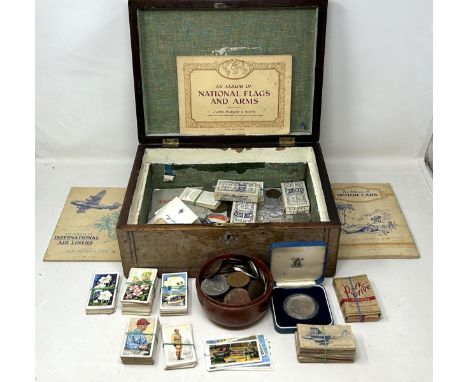 Assorted coins and cigarette cards, in a rosewood box