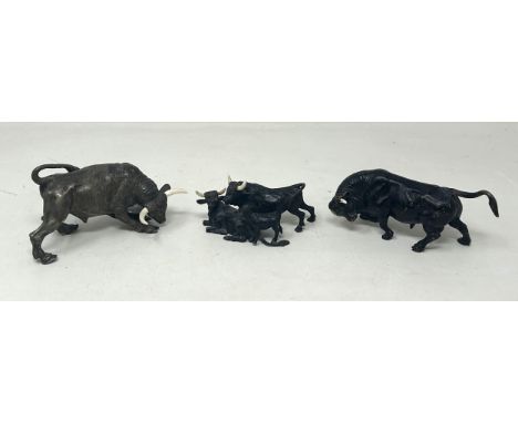 A bronze figure of a bull, 5.5 cm high, and two other similar bull figures/groups (3)