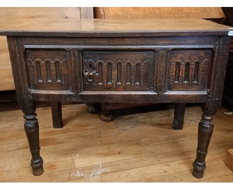 A oak side table, with 1 cupboard door, 78 cm highvariation of colour, some ring marks, one of the top planks are slightly lo