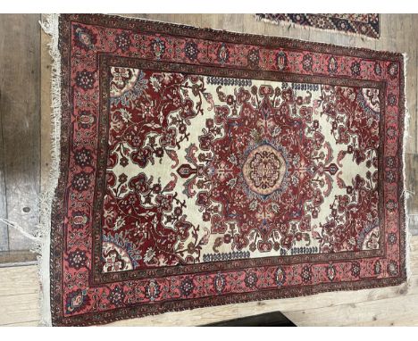 A Persian red ground rug, 182 x 132 cm