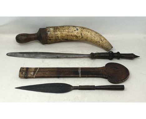 An Eastern sword, in a leather sheath, 57 cm, a powder horn and a spearhead (3)