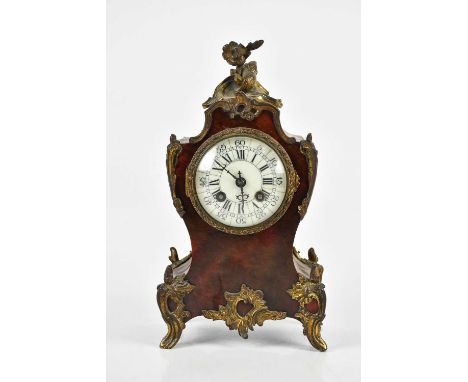 A late 19th century tortoiseshell veneered mantel clock, with floral finial and applied gilt metal decoration surrounding the