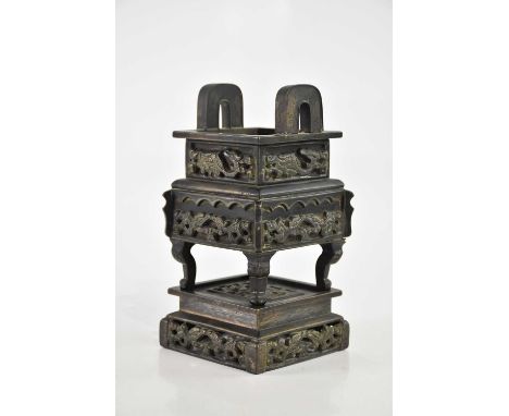 A Chinese cast metal twin handled censer, relief decorated with a dragon, with impressed four character seal mark, with detac