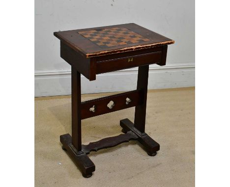 A Victorian stained pine Gothic Revival games table, with chessboard top above a single drawer, height 72cm, width 51cm.